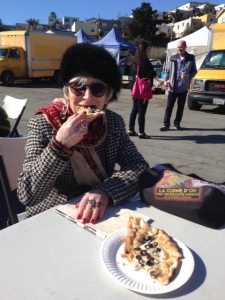 Eating thin crusted pizza at Almany farmer's market